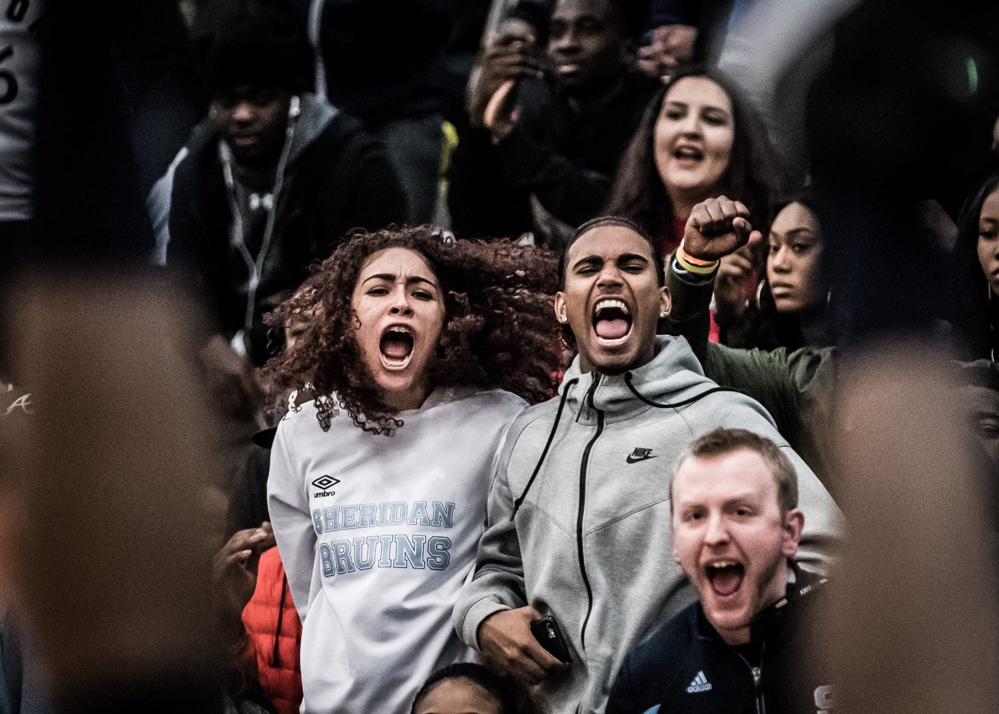 TORONTO, ON – Mar. 3, 2017: Bruins fans react after Paul Williams drains a basket (in the foreground) and gets the foul call.