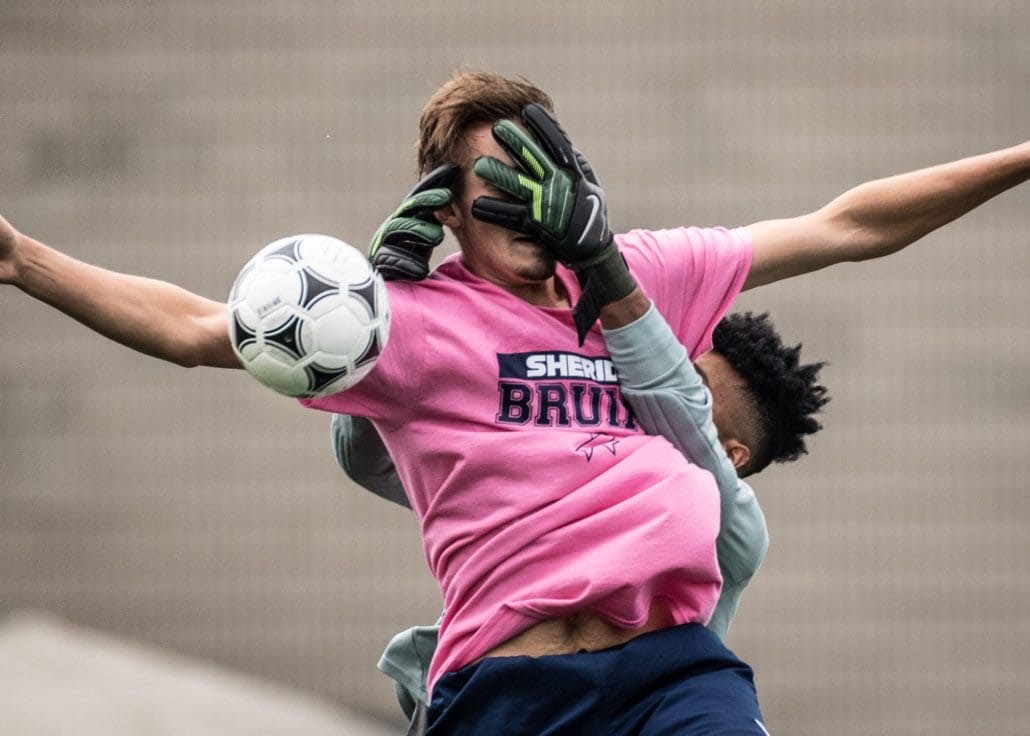 OAKVILLE, ON - Oct. 1, 2016: The George Brown Huskies goalkeeper reaches for the ball in a game against the Sheridan Bruins.
