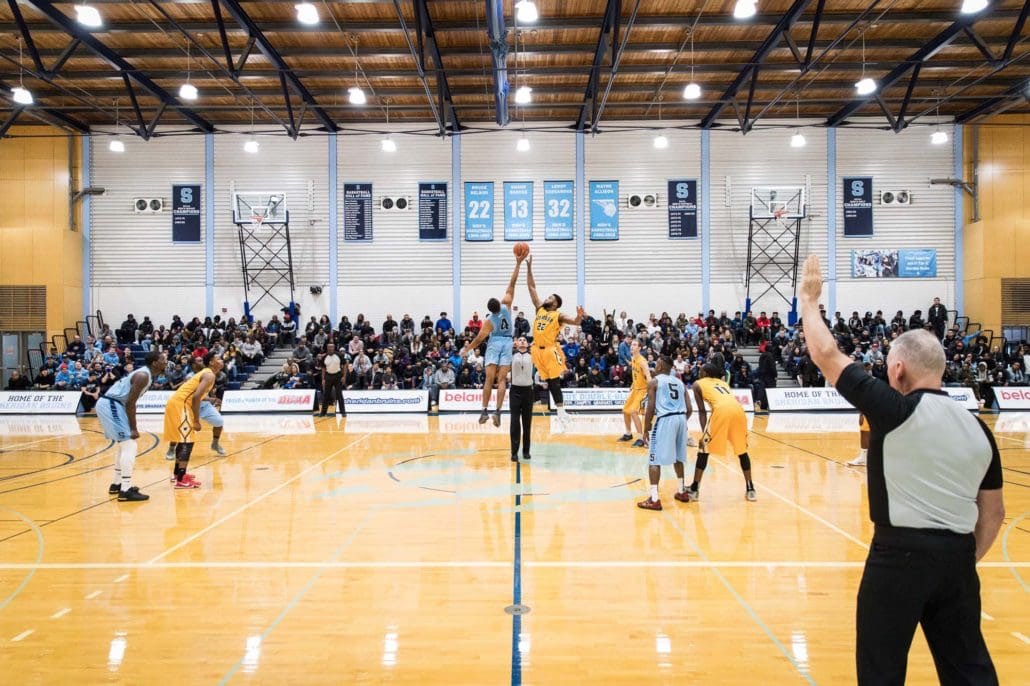 BRAMPTON, ON - NOV. 23, 2017: Tip off at the 118th edition of 'The Game' between the Sheridan Bruins and the Humber Hawks.