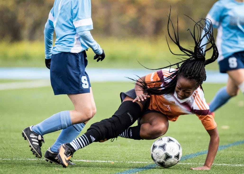 OAKVILLE, ON - Oct. 22, 2016: A Mohawk player falls to the ground after a crunching tackle.